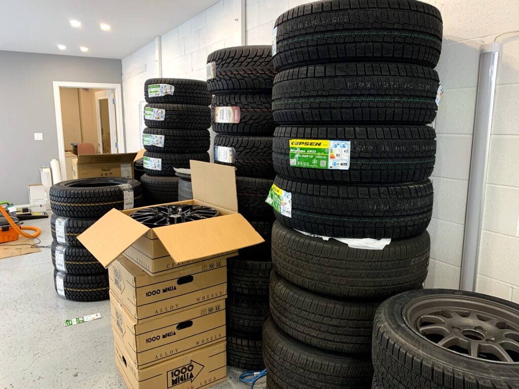 4 stacks of new tires in storage