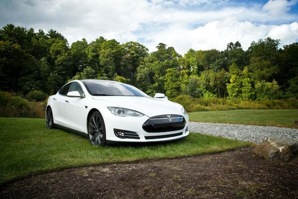photo of tesla model S parked on the grass