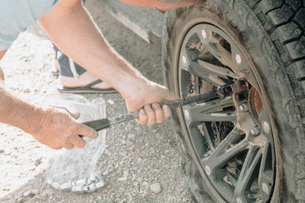 photo of someone diy tire change at home